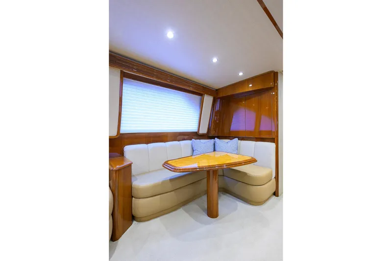  Yacht Photos Pics Luxurious interior of 2015 Viking 62 Convertible yacht with elegant seating and table.