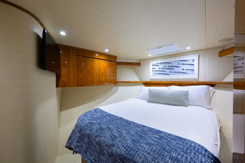  Yacht Photos Pics Luxurious cabin interior of 2015 Viking 62 Convertible yacht with cozy bed and elegant decor.