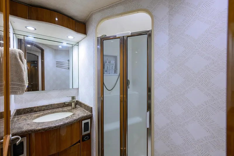  Yacht Photos Pics Luxurious bathroom in 2015 Viking 62 Convertible yacht with modern fixtures and elegant design.