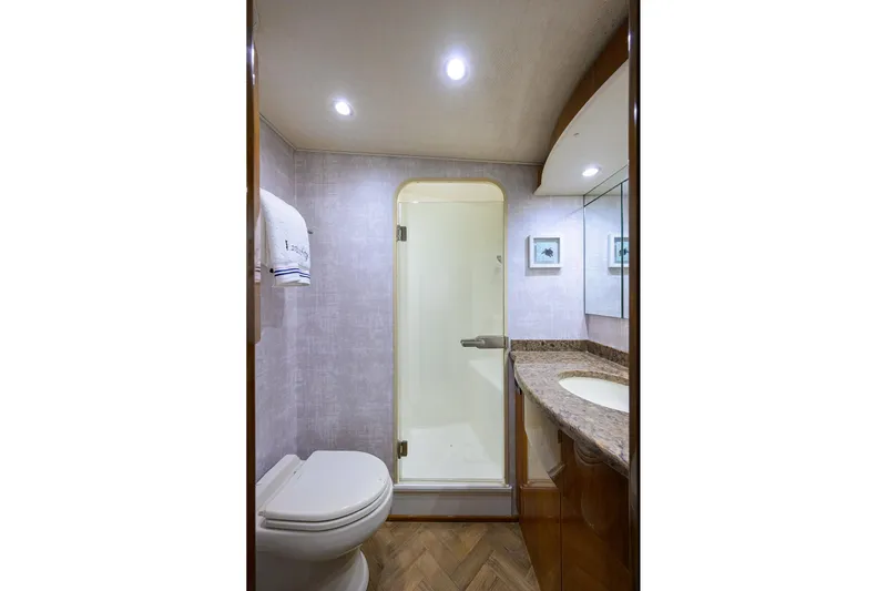  Yacht Photos Pics Luxurious bathroom in 2015 Viking 62 Convertible yacht with shower and elegant fixtures.