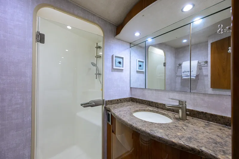  Yacht Photos Pics Luxurious bathroom in 2015 Viking 62 Convertible yacht with granite countertop and shower.