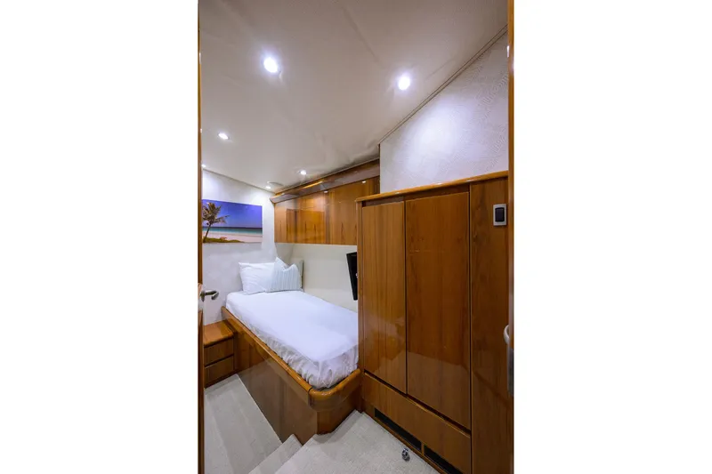  Yacht Photos Pics Luxurious cabin interior of 2015 Viking 62 Convertible yacht with wooden furnishings.