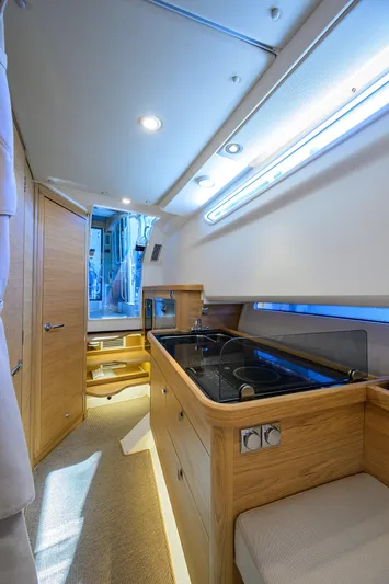 Sea Nn Me III Yacht Photos Pics 2024 Nimbus C11 yacht interior with modern kitchen and wooden cabinetry.