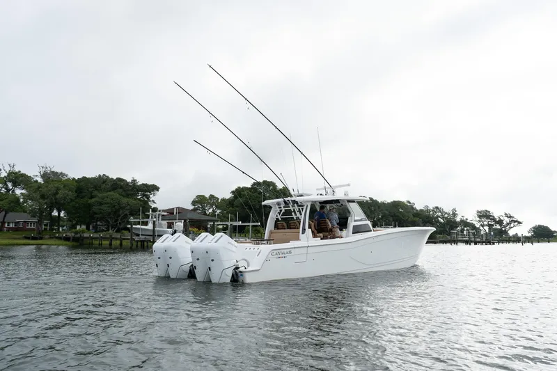  Yacht Photos Pics 2025 Caymas 44 CT boat with triple engines on a calm lake.