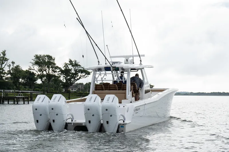  Yacht Photos Pics 2025 Caymas 44 CT boat with four engines cruising on a calm lake.