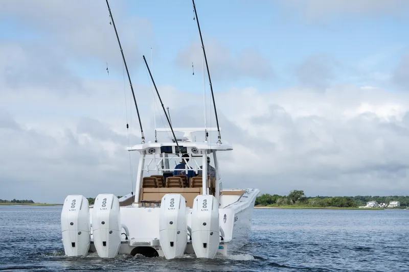  Yacht Photos Pics 2025 Caymas 44 CT boat with multiple outboard engines on open water.