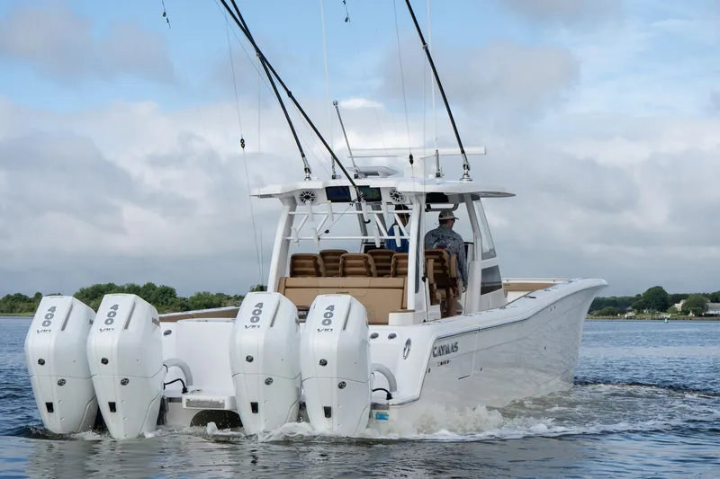  Yacht Photos Pics 2025 Caymas 44 CT boat with four powerful engines cruising on water.