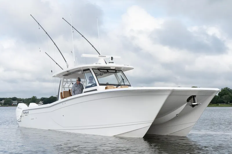  Yacht Photos Pics 2025 Caymas 44 CT boat on water, featuring sleek design and fishing rods.