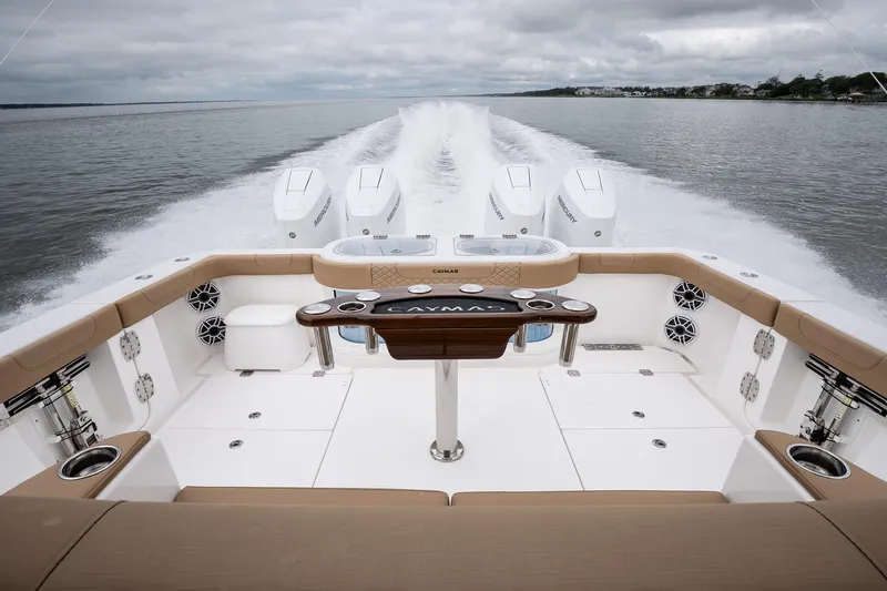  Yacht Photos Pics 2025 Caymas 44 CT boat cruising on open water, showcasing powerful engines and spacious deck.