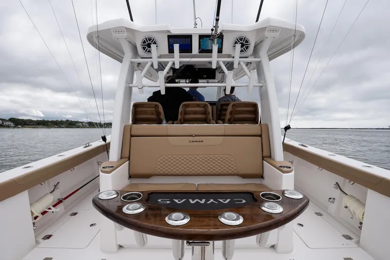  Yacht Photos Pics 2025 Caymas 44 CT boat interior with seating and fishing rod holders on a cloudy day.