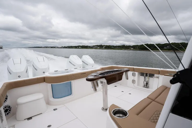  Yacht Photos Pics 2025 Caymas 44 CT boat cruising on a lake under cloudy skies.