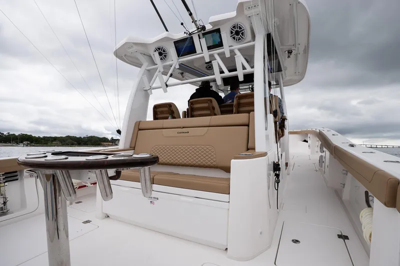  Yacht Photos Pics 2025 Caymas 44 CT boat interior with seating and helm, under cloudy skies.
