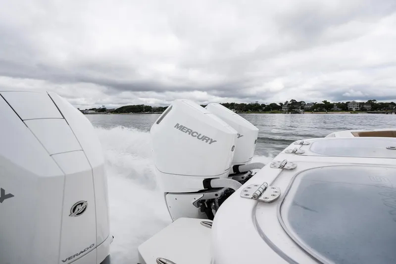  Yacht Photos Pics 2025 Caymas 44 CT boat with Mercury engines cruising on a cloudy day.