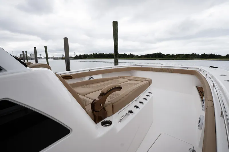  Yacht Photos Pics 2025 Caymas 44 CT boat with luxurious seating, docked by a serene waterfront.