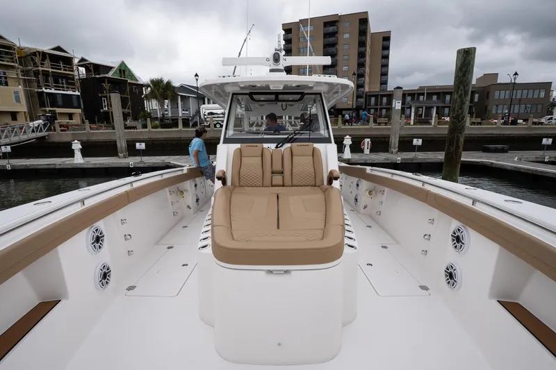  Yacht Photos Pics 2025 Caymas 44 CT boat with tan seating, docked at a marina under cloudy skies.