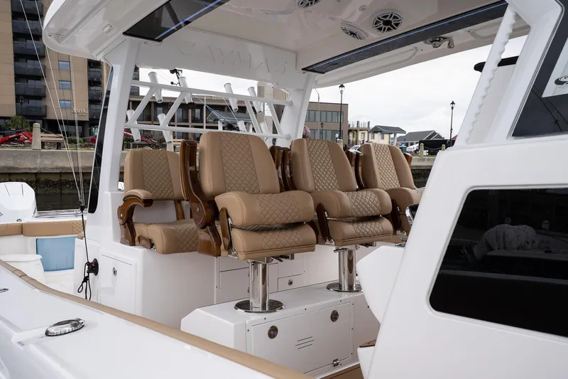  Yacht Photos Pics Luxurious seating on 2025 Caymas 44 CT boat, docked in a marina.