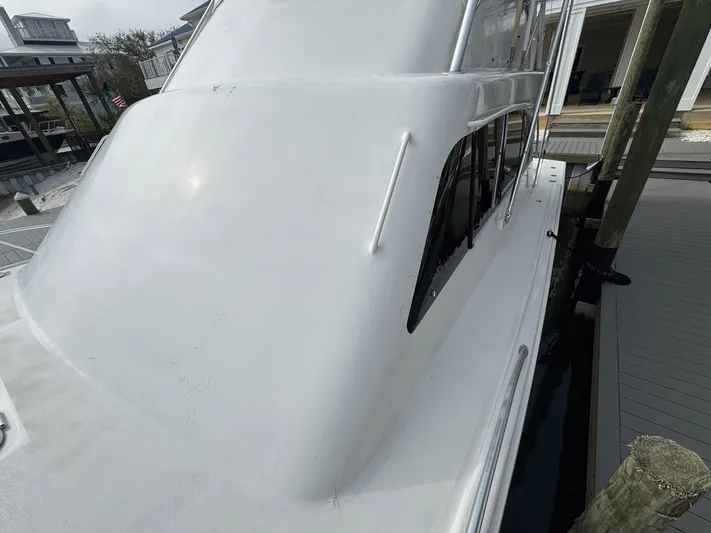 Reel Outlaw Yacht Photos Pics 1998 Richards Yachts Custom Flybridge Sportfish docked, showcasing sleek white exterior design.