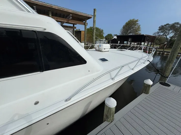 Reel Outlaw Yacht Photos Pics 1998 Richards Yachts Custom Flybridge Sportfish docked at marina, side view.