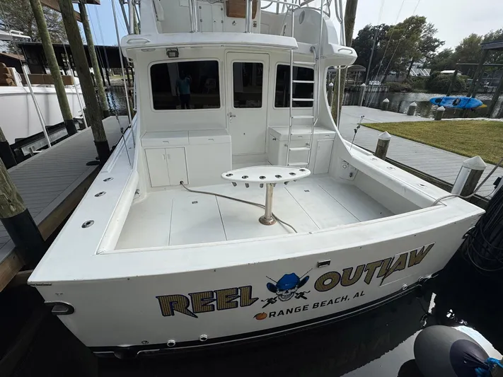 Reel Outlaw Yacht Photos Pics 1998 Richards Yachts Custom Flybridge Sportfish docked, featuring "Reel Outlaw" branding, Orange Beach, AL.