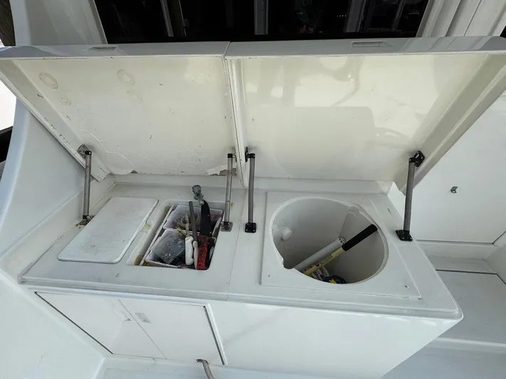 Reel Outlaw Yacht Photos Pics Open storage compartments on 1998 Richards Yachts Custom Flybridge Sportfish, featuring fishing gear and tools.
