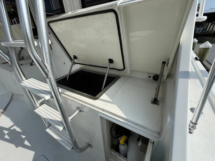 Reel Outlaw Yacht Photos Pics Open storage compartment on 1998 Richards Yachts Custom Flybridge Sportfish boat deck.