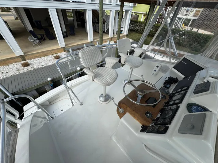 Reel Outlaw Yacht Photos Pics Flybridge of 1998 Richards Yachts Custom Sportfish with helm, controls, and seating.