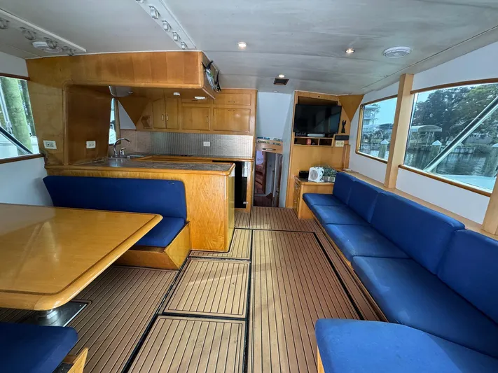 Reel Outlaw Yacht Photos Pics Luxurious 1998 Richards Yachts Custom Flybridge Sportfish interior with wood finish and blue seating.