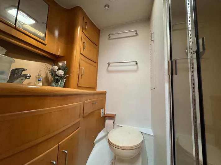 Reel Outlaw Yacht Photos Pics Luxurious 1998 Richards Yachts Custom Flybridge Sportfish bathroom with wooden cabinetry and modern fixtures.