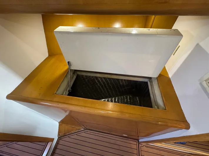 Reel Outlaw Yacht Photos Pics Open storage compartment on 1998 Richards Yachts Custom Flybridge Sportfish with wooden trim.