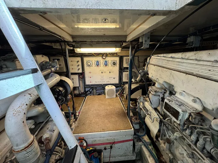 Reel Outlaw Yacht Photos Pics Engine room of 1998 Richards Yachts Custom Flybridge Sportfish, showcasing control panels and machinery.