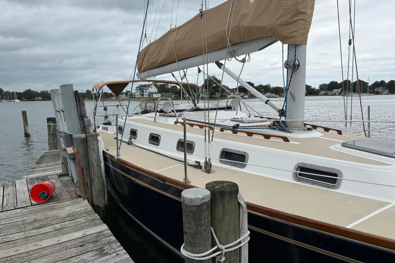 Celebration Yacht Photos Pics Sailboat docked at marina, Tartan 4100 model, 2001, with beige deck and tan sail cover.