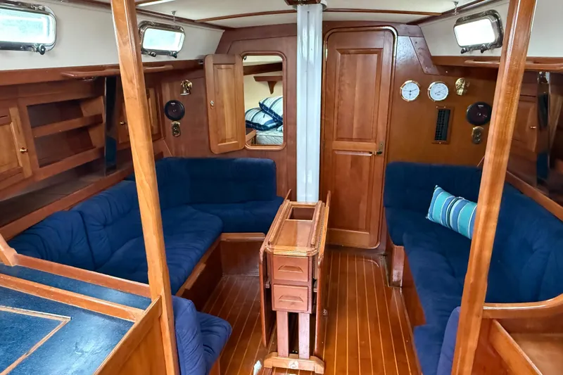 Celebration Yacht Photos Pics Interior of 2001 Tartan 4100 sailboat with wooden finish and blue seating.