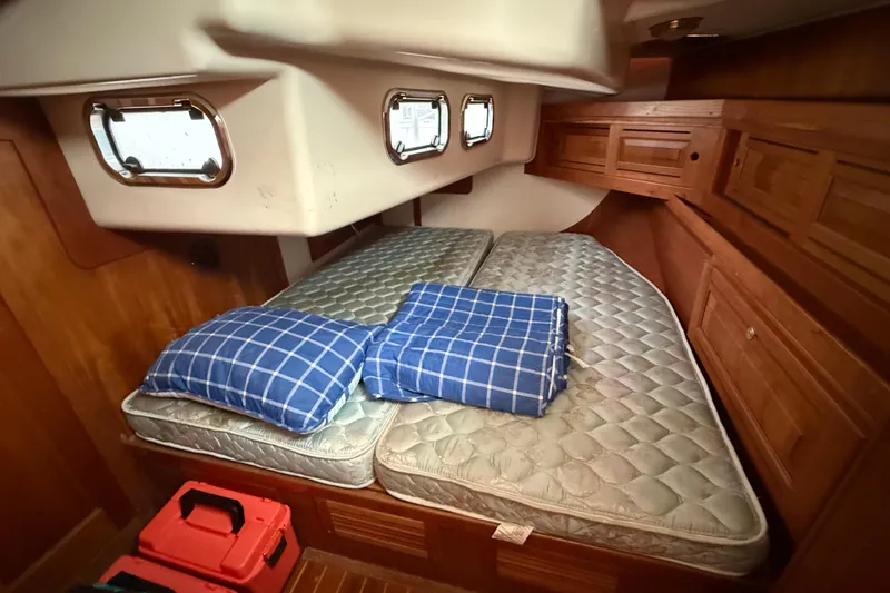 Celebration Yacht Photos Pics Cozy cabin interior of 2001 Tartan 4100 sailboat with blue plaid bedding.