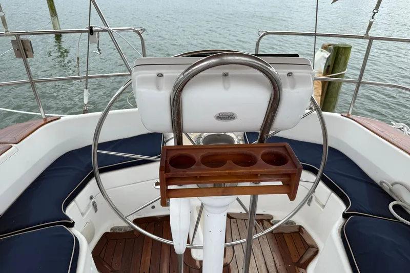 Celebration Yacht Photos Pics Cockpit of 2001 Tartan 4100 sailboat with steering wheel and cup holder.
