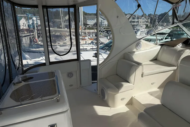 Cato Yacht Photos Pics 2003 Cruisers Yachts 4050 Express interior with white seating and marina view.