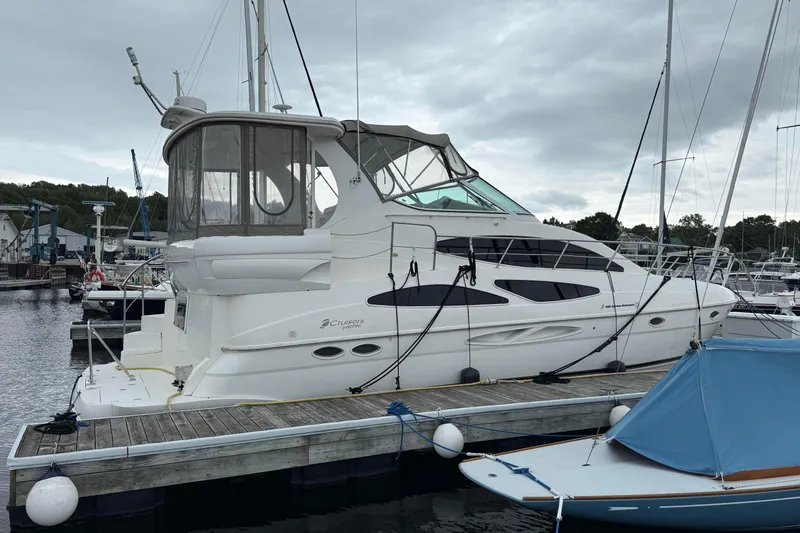 Cato Yacht Photos Pics 2003 Cruisers Yachts 4050 Express docked at marina under cloudy sky.