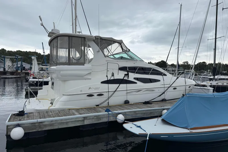Cato Yacht Photos Pics 2003 Cruisers Yachts 4050 Express docked at marina under cloudy sky.