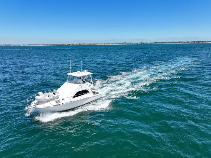 Legacy Yacht Photos Pics 2004 Cabo 40 Flybridge Convertible cruising on open blue water.