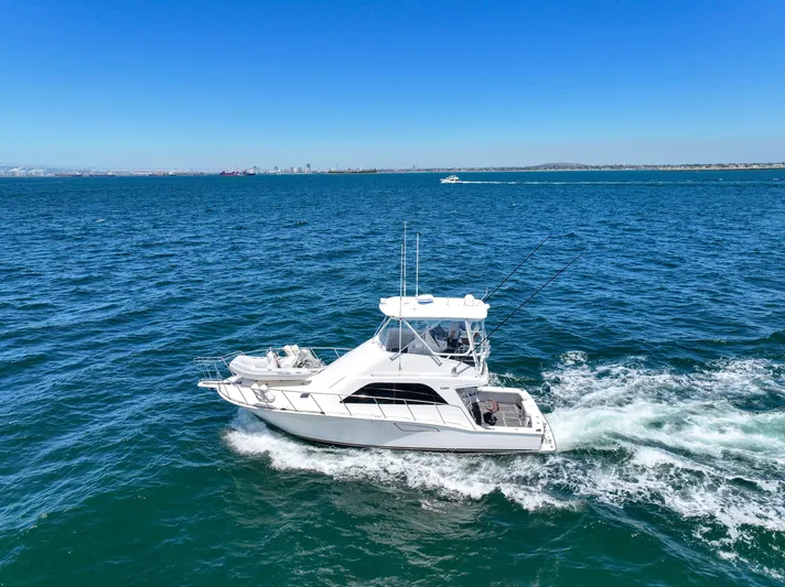 Legacy Yacht Photos Pics 2004 Cabo 40 Flybridge Convertible cruising on open blue water.