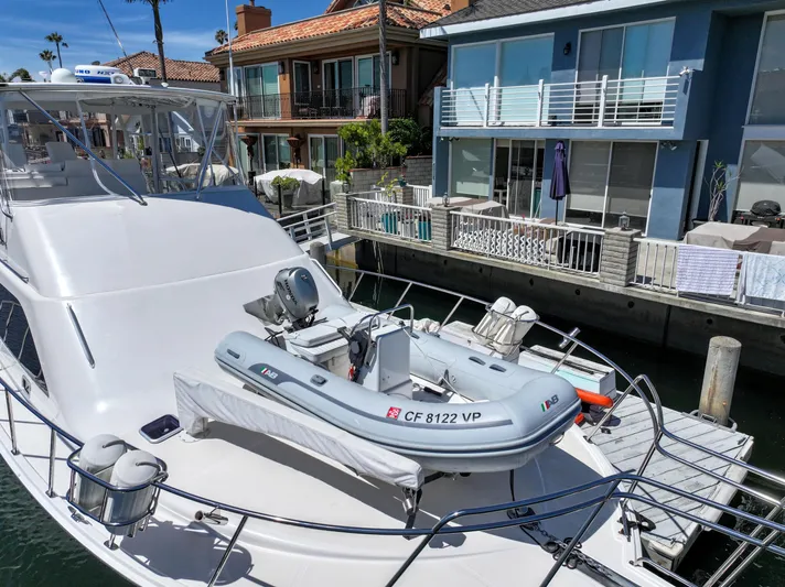 Legacy Yacht Photos Pics 2004 Cabo 40 Flybridge Convertible yacht docked near waterfront homes.