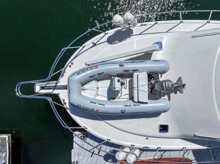 Legacy Yacht Photos Pics Aerial view of 2004 Cabo 40 Flybridge Convertible with inflatable boat on deck.