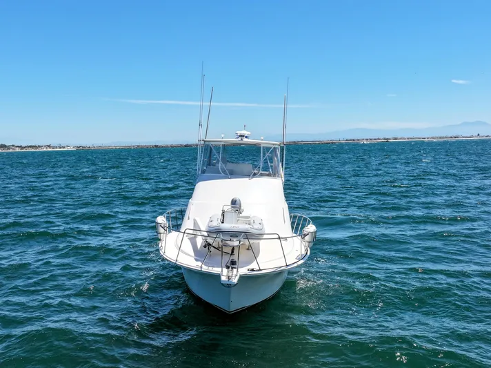 Legacy Yacht Photos Pics 2004 Cabo 40 Flybridge Convertible boat on open water under clear blue sky.