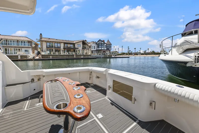 Legacy Yacht Photos Pics 2004 Cabo 40 Flybridge Convertible yacht deck with scenic waterfront view.