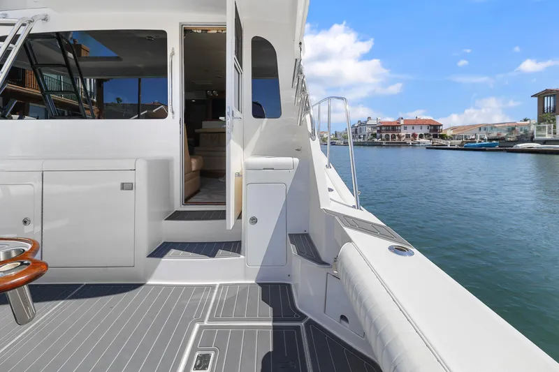 Legacy Yacht Photos Pics 2004 Cabo 40 Flybridge Convertible yacht docked by waterfront homes.