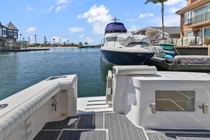 Legacy Yacht Photos Pics 2004 Cabo 40 Flybridge Convertible docked in a scenic marina setting.