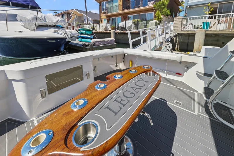Legacy Yacht Photos Pics 2004 Cabo 40 Flybridge Convertible yacht deck with "Legacy" fishing station, docked in marina.