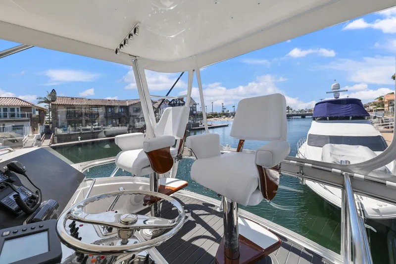 Legacy Yacht Photos Pics Flybridge view of 2004 Cabo 40 Convertible yacht in marina setting.