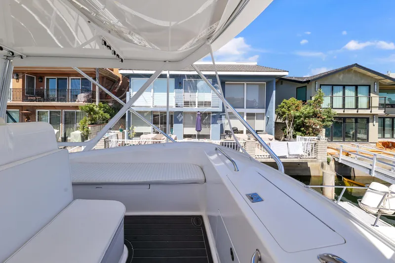 Legacy Yacht Photos Pics 2004 Cabo 40 Flybridge Convertible yacht docked near waterfront homes.