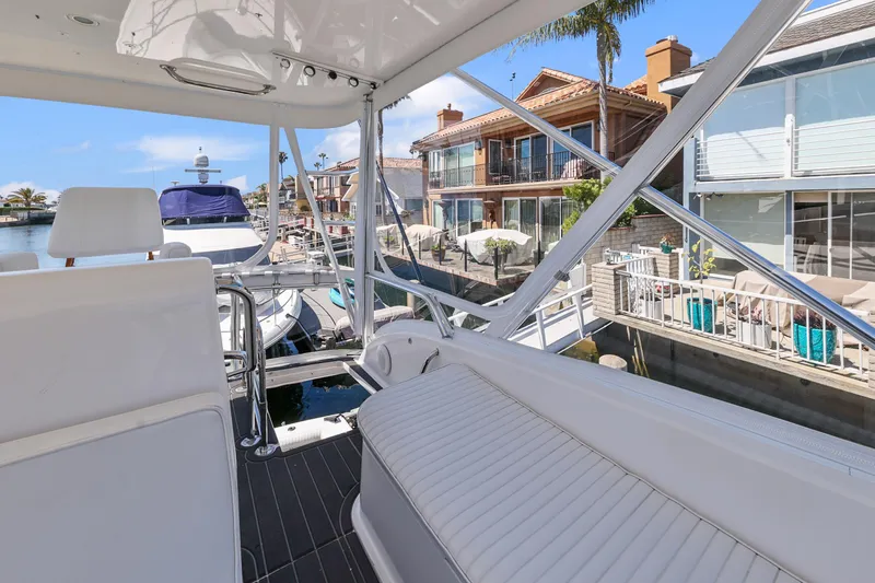 Legacy Yacht Photos Pics 2004 Cabo 40 Flybridge Convertible yacht docked near waterfront homes.