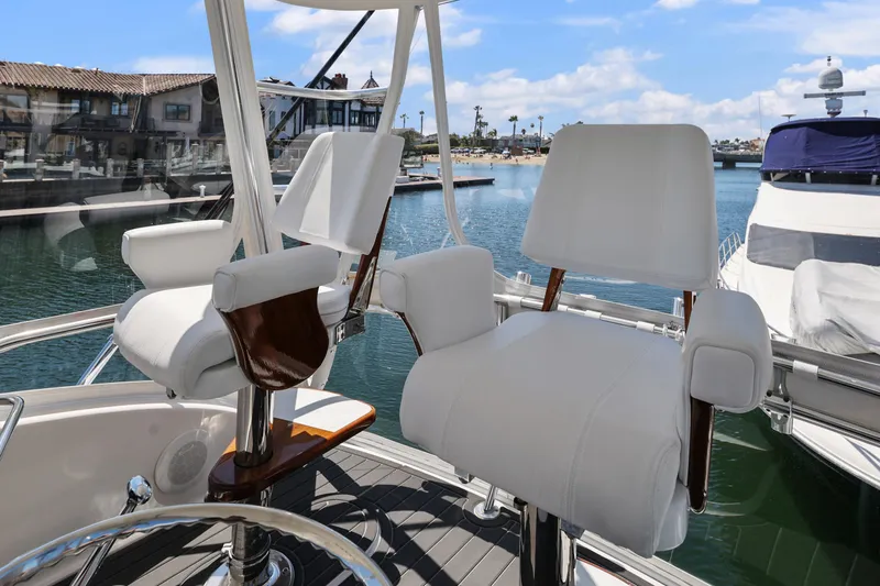 Legacy Yacht Photos Pics 2004 Cabo 40 Flybridge Convertible helm chairs overlooking marina.